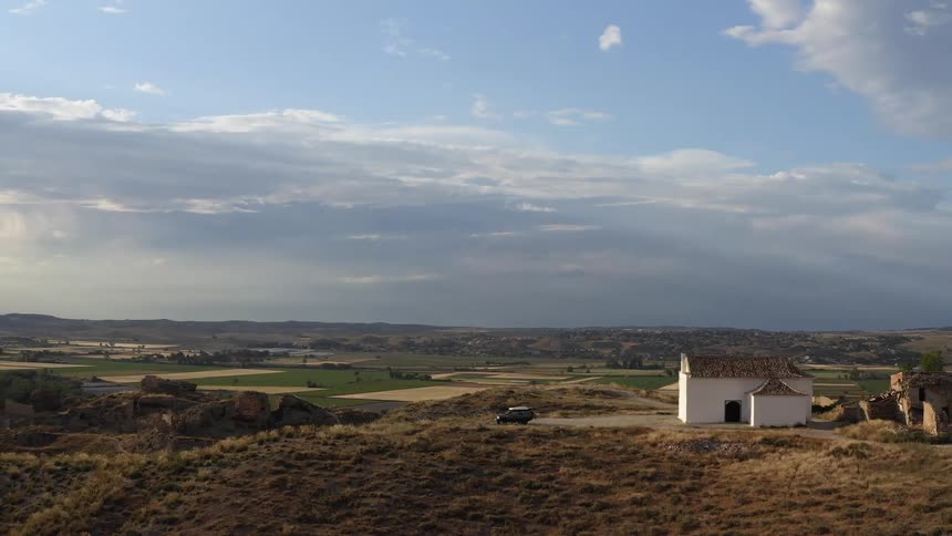 A single house sits on the hill near the fields