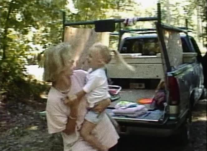 Vintage vhs film of a mother and daughter dancing outdoors in front of a truck