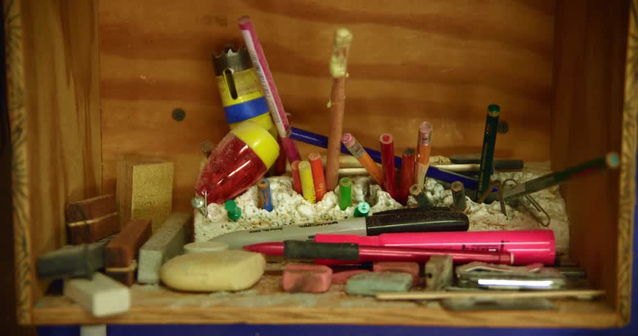 The shelf is full of writing supplies