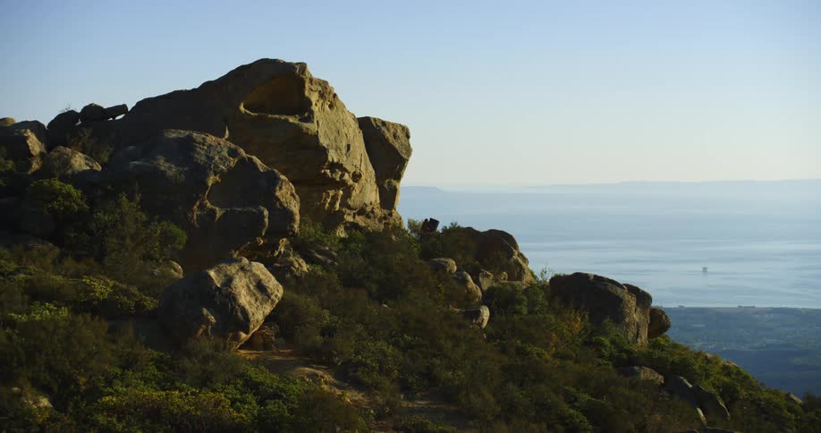 A person climbs up the rocks on the mountain