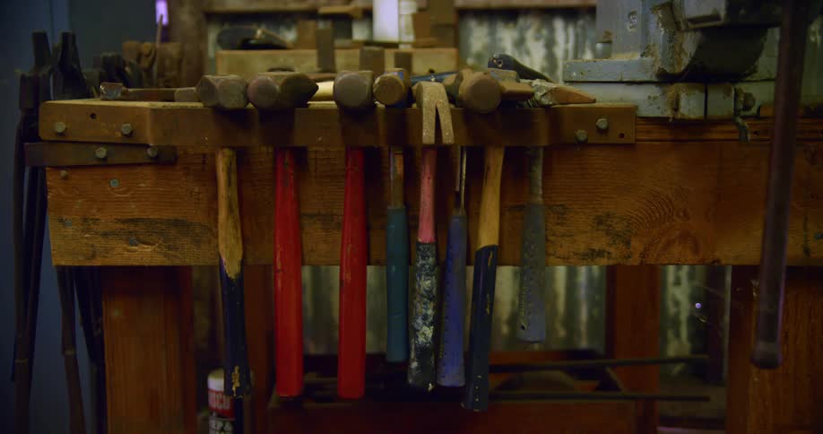 Hammers hanging on a work bench