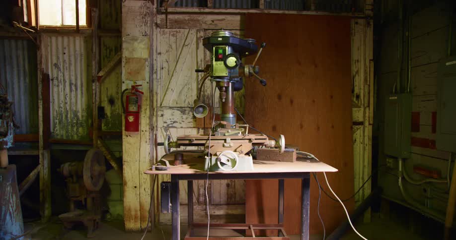 Electric industrial drill on a workbench inside a workshop