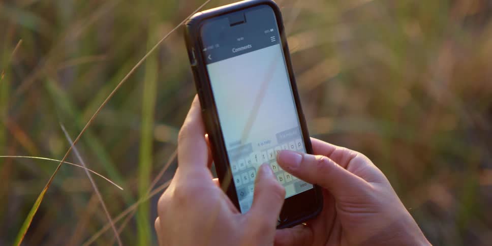 A person is typing on their cell phone