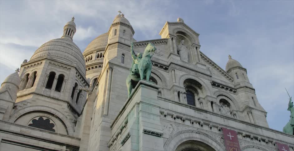 Close up of a building with a green statue on a wall
