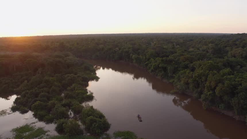 People paddling a boat down a river