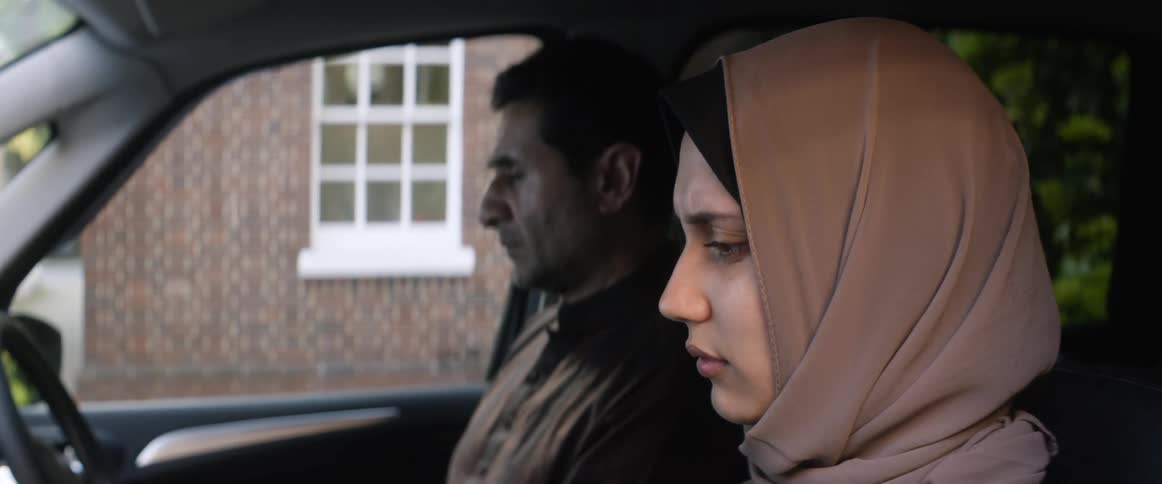 A man and woman are sitting in the car