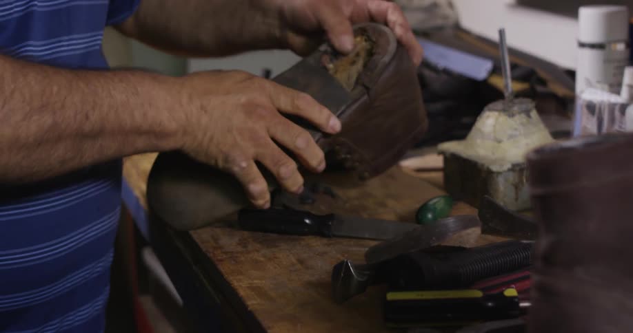 A man peels the heel off a shoe