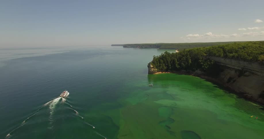 A boat floats just off the coast
