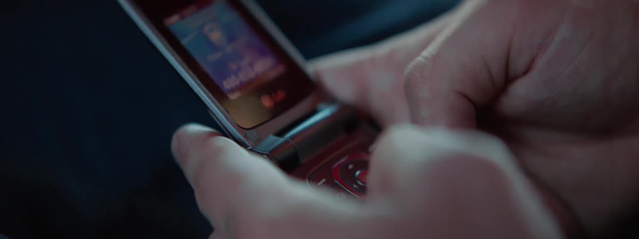 Mans hands uses a smart phone to make a call