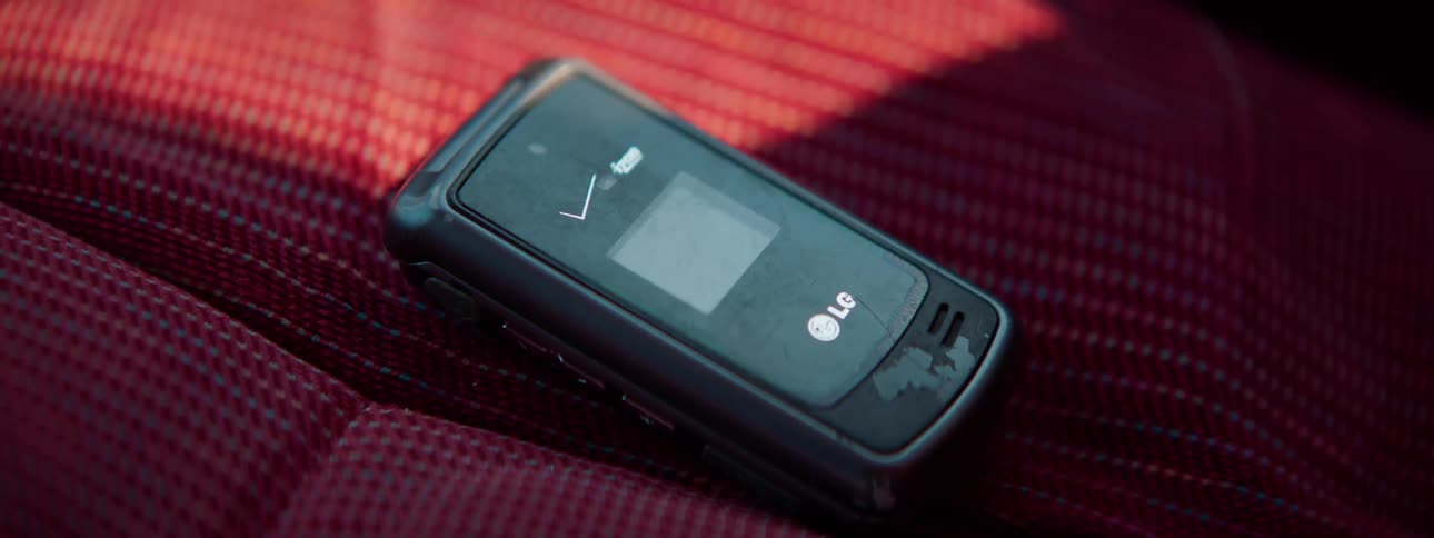A mobile phone sitting on a cushion