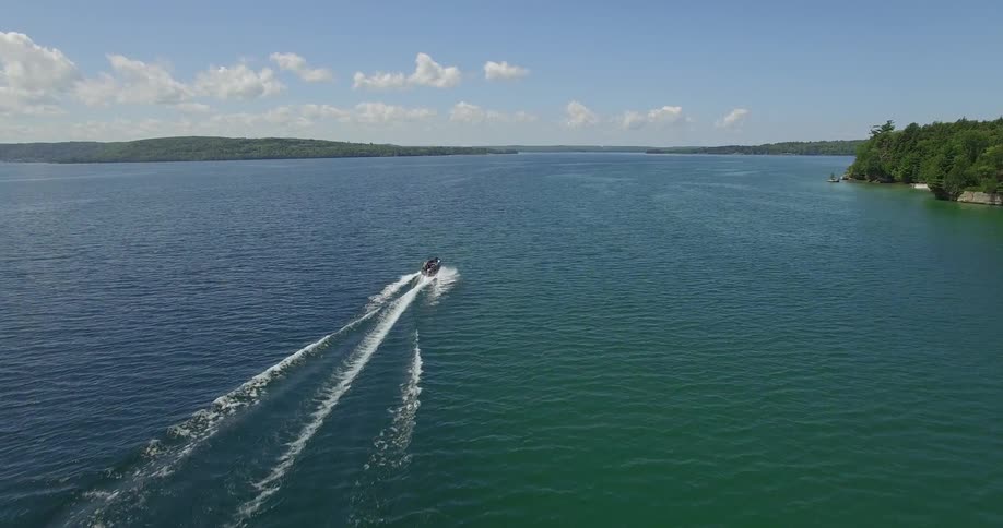 Aerial view of a boat speeding off into the waters