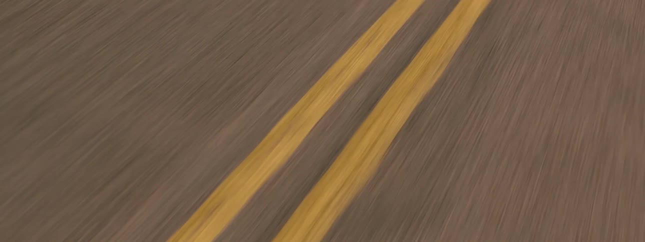 A person is driving a truck down a road