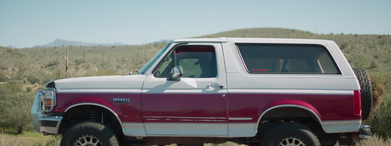 A man sits in the parked car