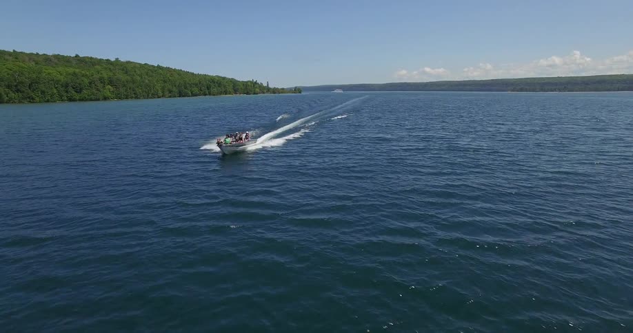 A boat speeds by on a lake