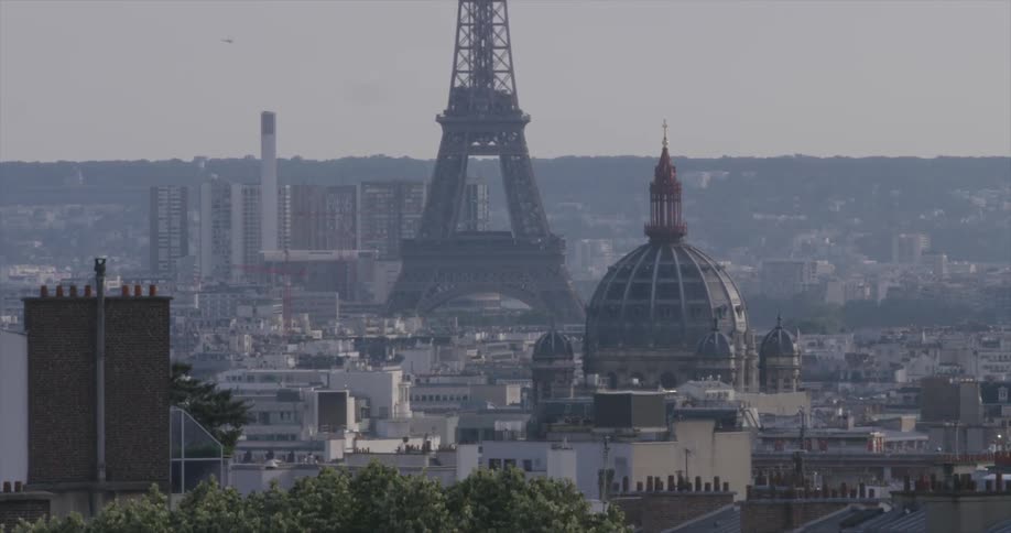A large city is covered with light fog on a cloudy day
