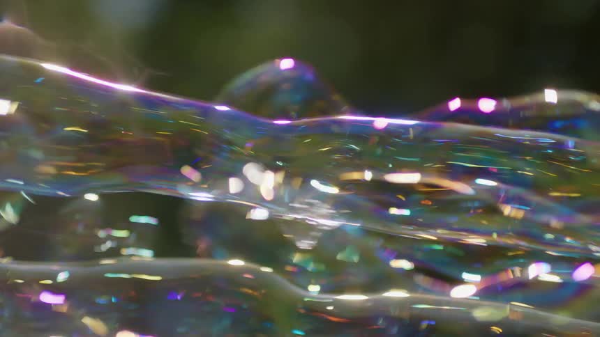 Reflective rainbows form on long bubbles blown outside