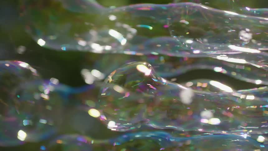 Large bubbles of various sizes shimmer in sun