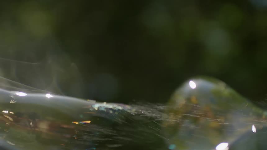Bubbles float in the air and pop
