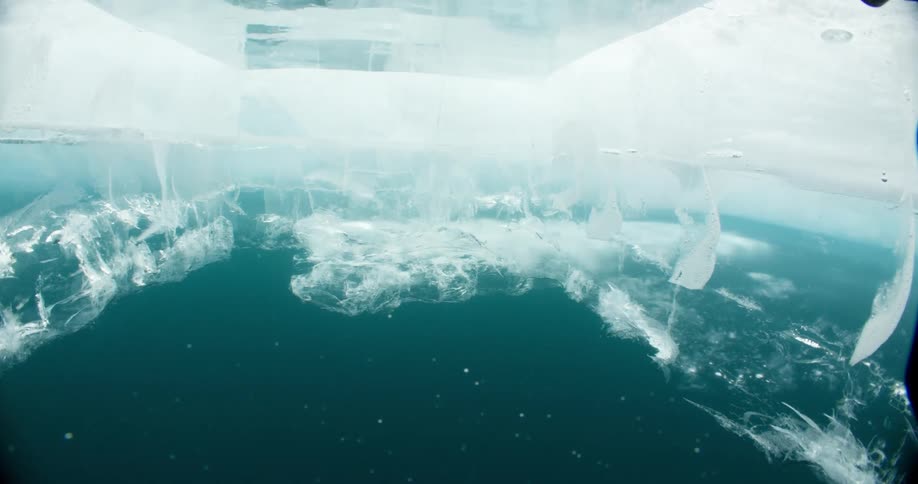 Underwater footage of a square hole cut on the frozen ice surface of sea ice