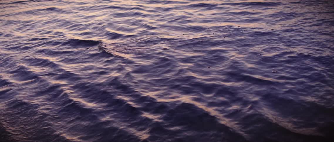 A flow of water with small waves and ripples