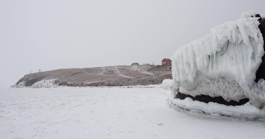 Ice and snow covering a lake and the shore