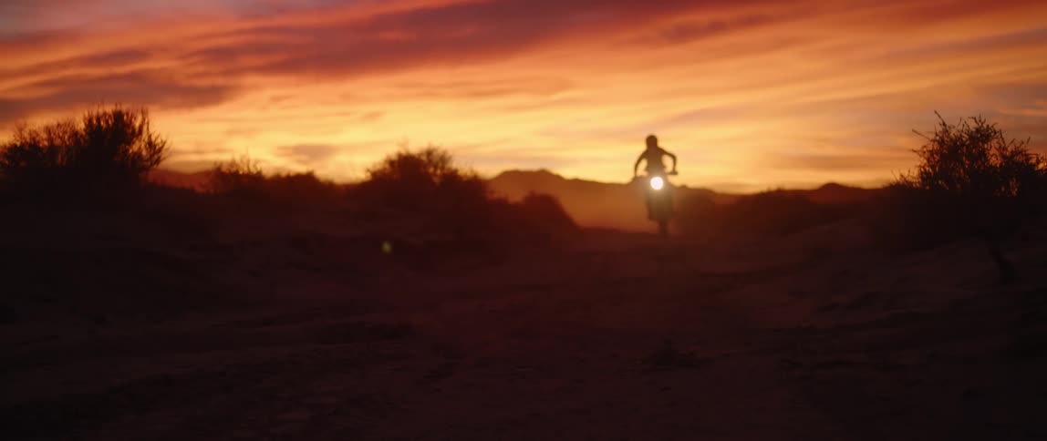 A person riding a dirt bike over the landscape