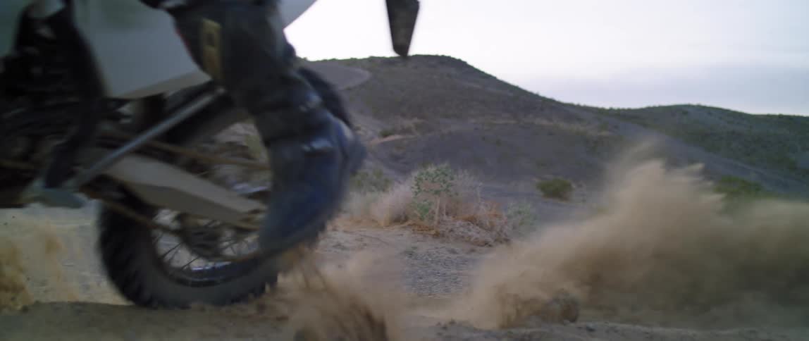 A person makes a sharp turn on their dirt bike