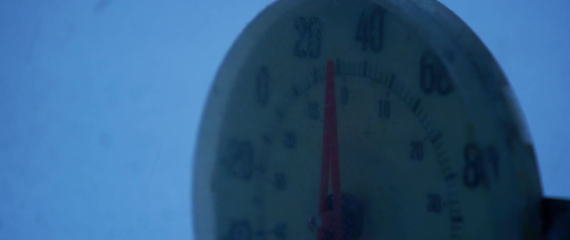 A temperature gauge reads cold temperatures during a winter storm