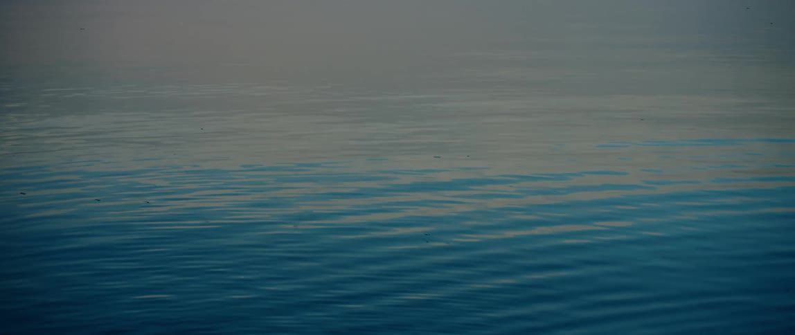 The sun sets on the rippling water