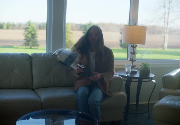 A woman sits down and opens her notebook