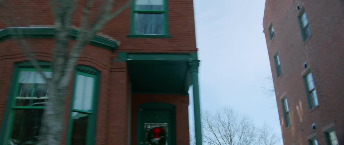 Buildings of a small city slowly pass by