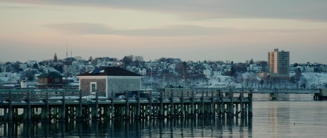 The sun sets on a wintery coastal city