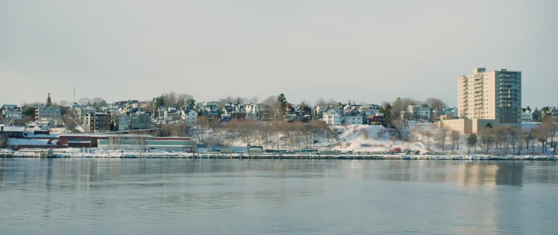 Passing by a small coastal city covered in snow