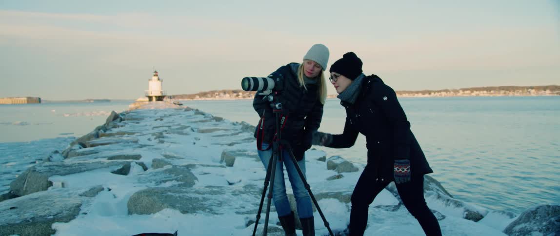 Two photographers collaborate on a winter landscape photograph