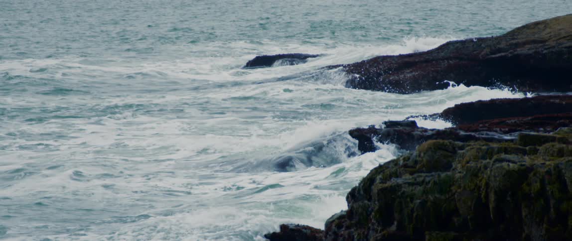 The swelling Atlantic Ocean crashes along the rocky coast of Maine