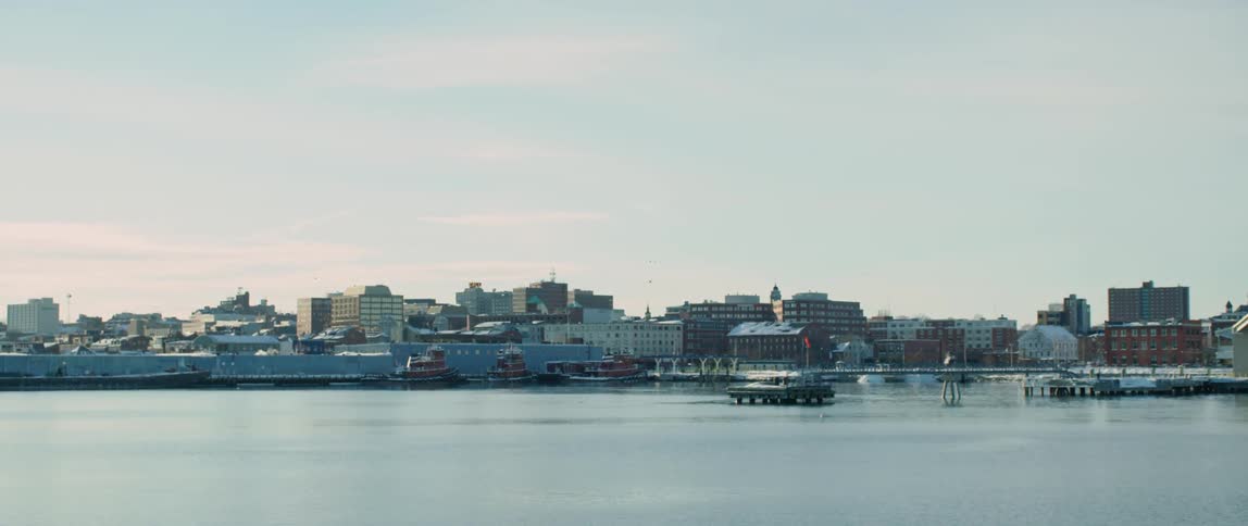 Approaching the docks along a small coastal city during winter