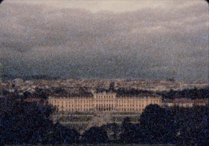The Schönbrunn Palace sits before the city of Vienna Austria at dusk