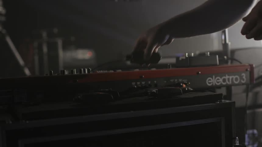 A person picks up an item by a musical instrument