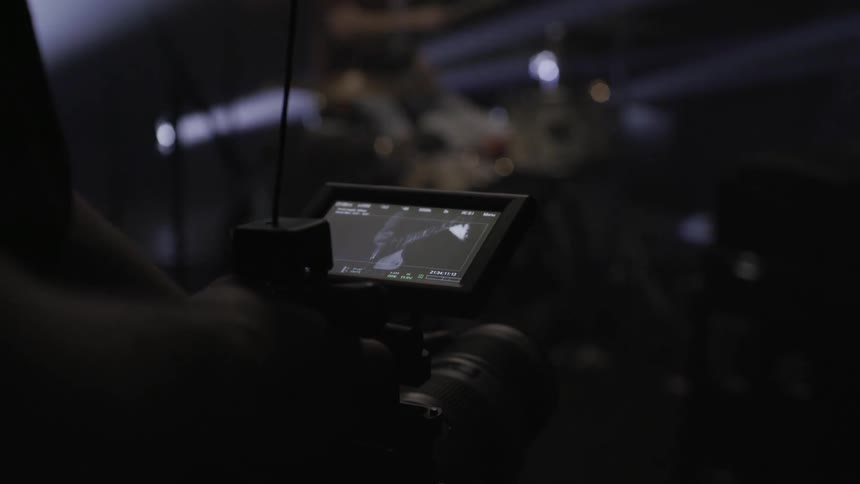 A camera person filming a drummer