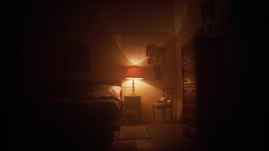 The lamp is turned on in the dark bedroom
