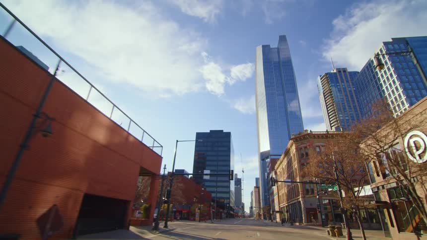 Driving on the empty streets of a citys downtown on a clear day