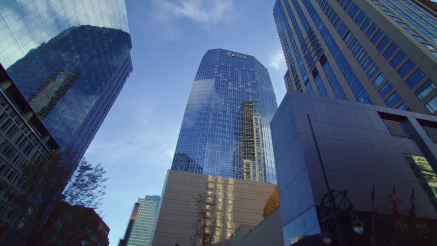 Skyscrapersreflect the sky and each other on a slightly cloudy day