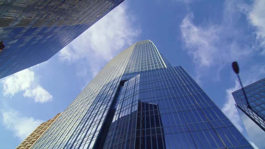 A skyscraper reflecting the sky in a metropolis on a sunny day