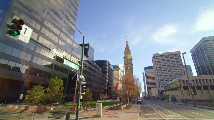 Skyscrapers line a city street on a sunny autumn day