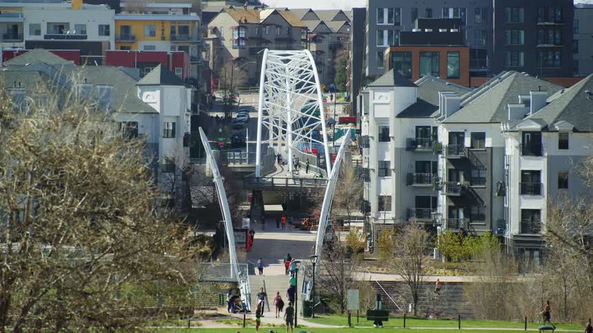 People walk towards the housing from the park