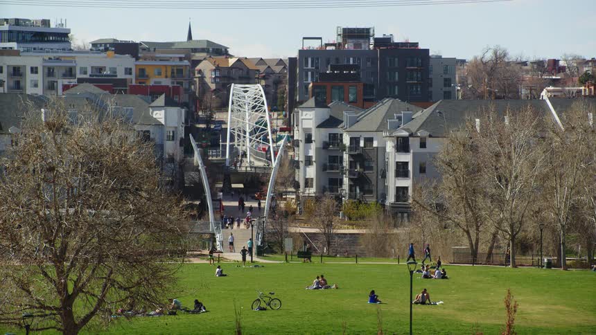 People enjoy a city park on a sunny spring day