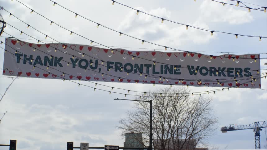 Street banner hanging downtown thanking frontline workers
