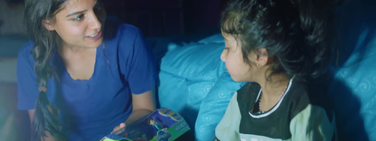 A mother shows a toy to a child