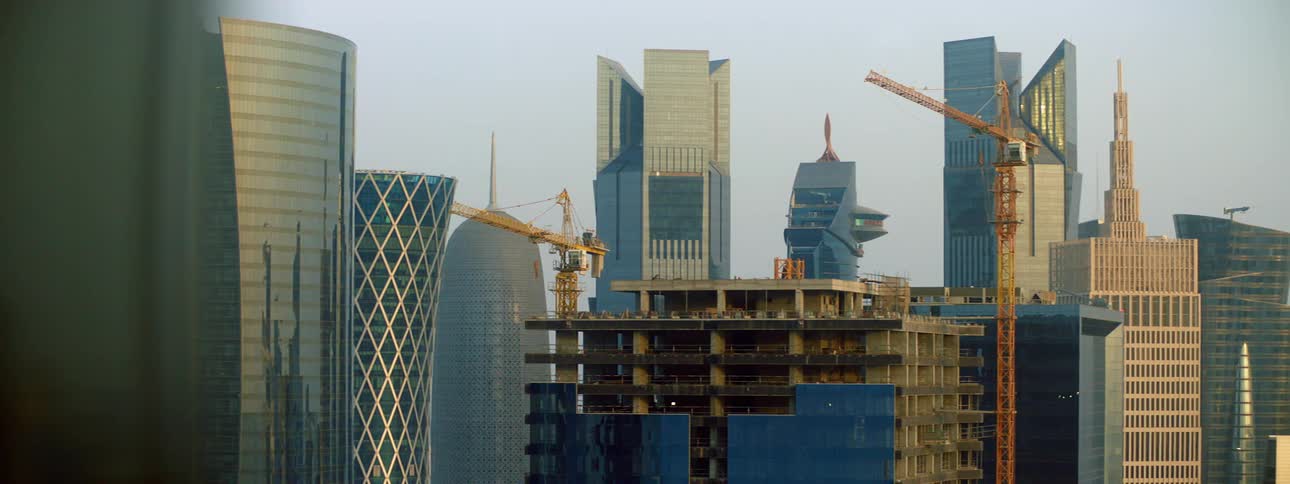 A construction crane over an office building in a down town area