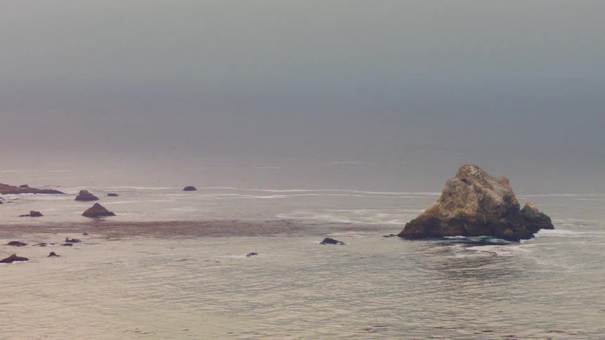 Rock promontory on the coast on an overcast day caught in film